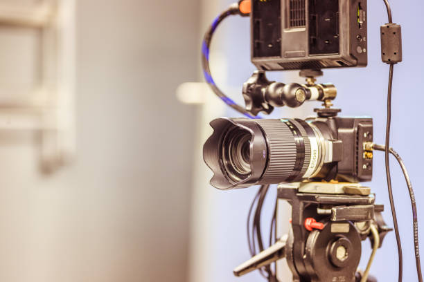 istock Modern film camera on a tripod in a broadcasting studio, spotlights and other equipment 1133559975