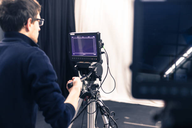 istock Modern film camera and cameraman in a broadcasting studio 1133559987