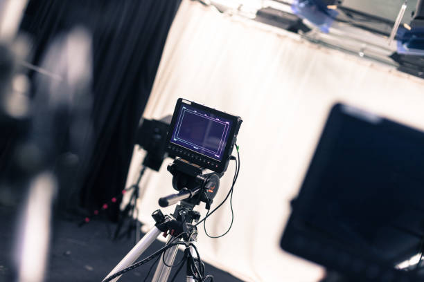 istock Modern film camera on a tripod in a broadcasting studio, spotlights and other equipment 1133559989