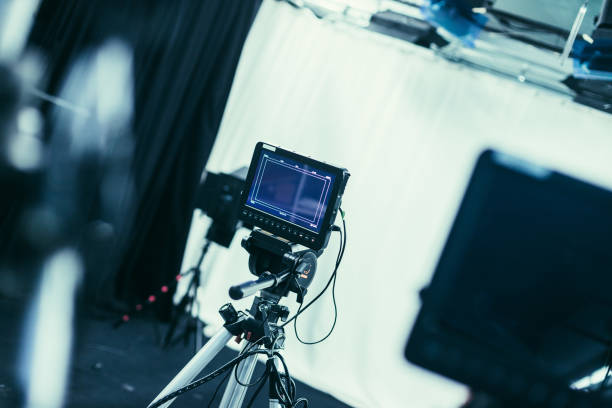 istock Modern film camera on a tripod in a broadcasting studio, spotlights and other equipment 1133559997