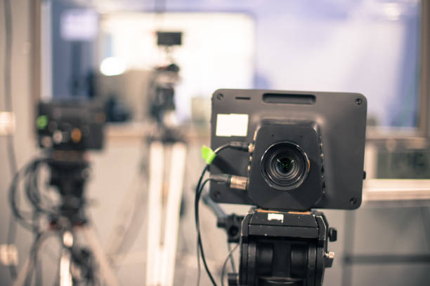 istock Modern film camera on a tripod in a broadcasting studio, spotlights and other equipment 1133560009