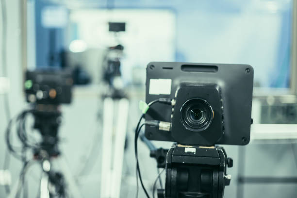 istock Modern film camera on a tripod in a broadcasting studio, spotlights and other equipment 1133560011