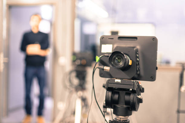 istock Modern film camera and cameraman in a broadcasting studio 1133560022