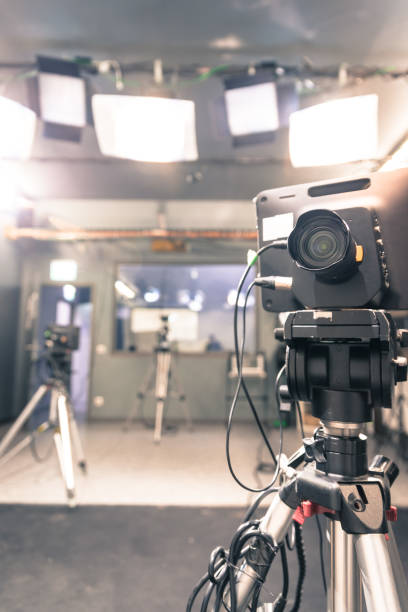 istock Modern film camera on a tripod in a broadcasting studio, spotlights and other equipment 1133560093