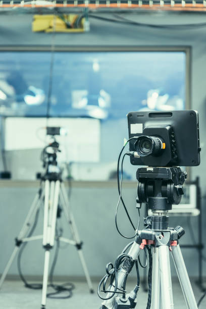 istock Modern film camera on a tripod in a broadcasting studio, spotlights and other equipment 1133560099