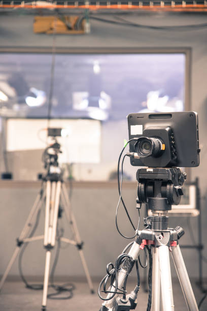 istock Modern film camera on a tripod in a broadcasting studio, spotlights and other equipment 1133560106