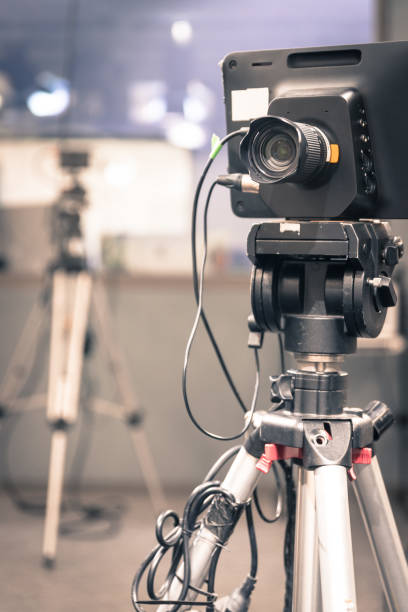 istock Modern film camera on a tripod in a broadcasting studio, spotlights and other equipment 1133560118