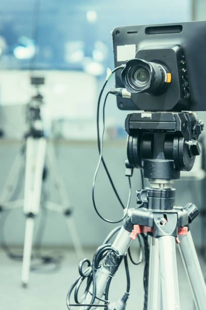 istock Modern film camera on a tripod in a broadcasting studio, spotlights and other equipment 1133560130