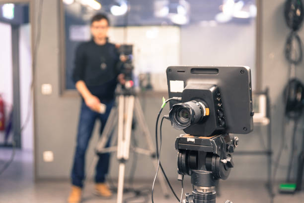 istock Modern film camera and cameraman in a broadcasting studio 1133560139
