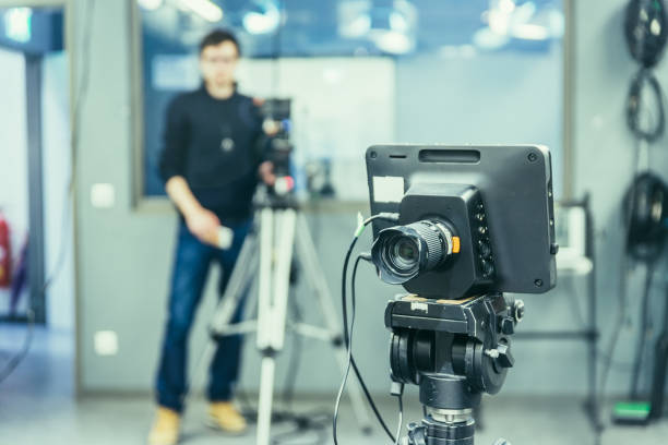 istock Modern film camera and cameraman in a broadcasting studio 1133560142