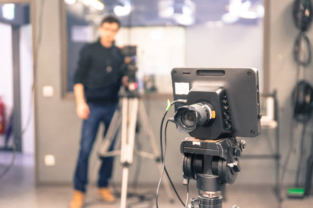 istock Modern film camera and cameraman in a broadcasting studio 1133560158
