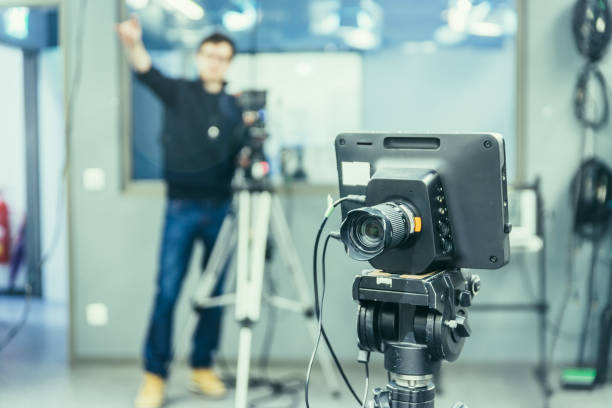 istock Modern film camera and cameraman in a broadcasting studio 1133560164