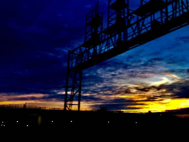 istock Train Track Sunset with Signal Lights 1133561021