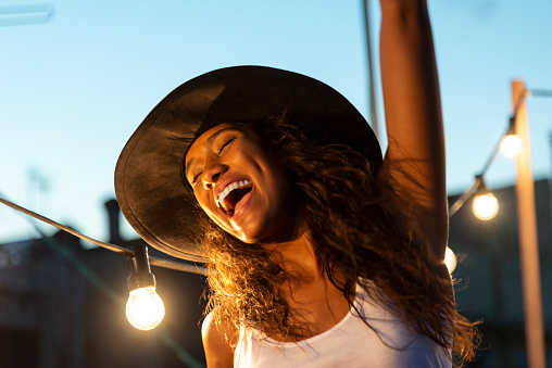 Beautiful girl with hat having fun at party, toothy smile, shot in Barcelona, Spain

.