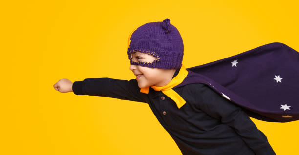 istock Little superhero flying on yellow 1133562276