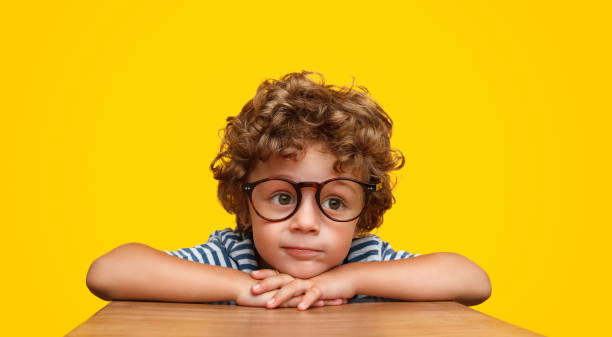 Smart curly boy in glasses