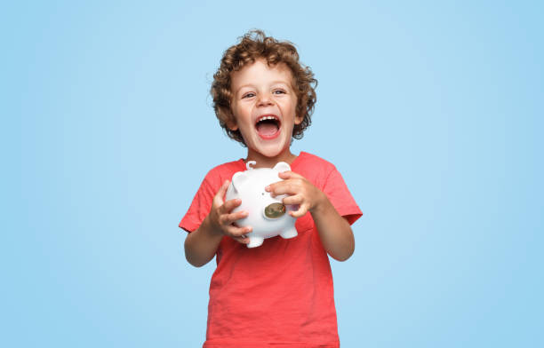 Excited boy with piggy bank