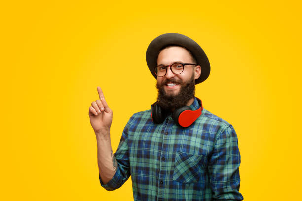 istock Hipster with headphones pointing up 1133562863