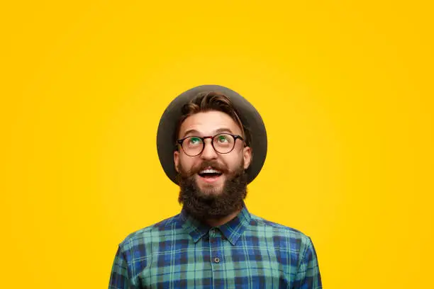 Photo of Excited man with beard looking up
