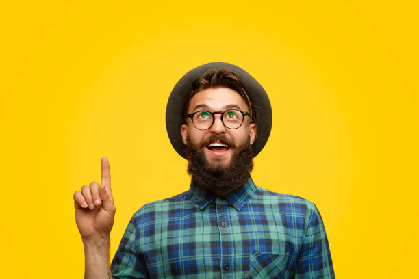 istock Bearded male pointing and looking up 1133562885