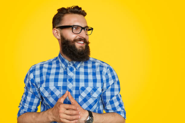 istock Stylish guy clasping hand and looking away 1133562894