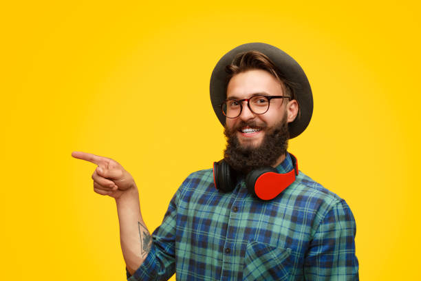 istock Trendy young man pointing away with finger 1133562895