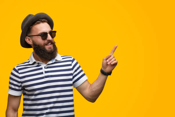 istock Stylish man in sunglasses pointing up 1133562916
