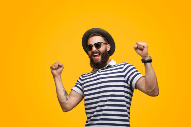 istock Man in striped T-shirt celebrating success 1133562918