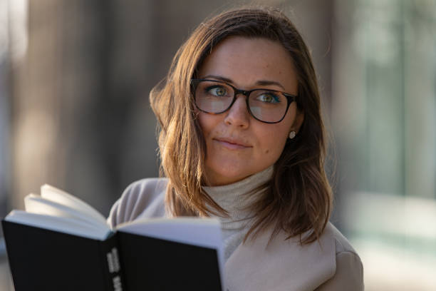 istock Woman reading in the city 1133563157