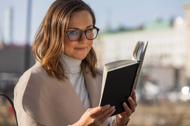 istock Woman reading in the city 1133563271