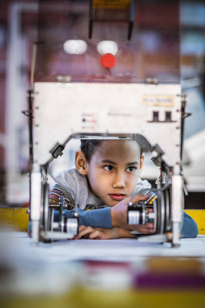 istock Small African American boy working on innovative equipment in laboratory 1133563947