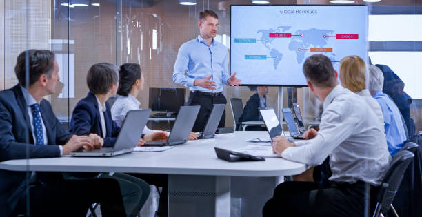 istock Businessman holding a presentation using display in glass conference room 1133565342