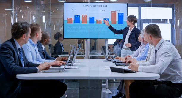 istock Businesswoman holding a presentation using display in glass conference room 1133565344