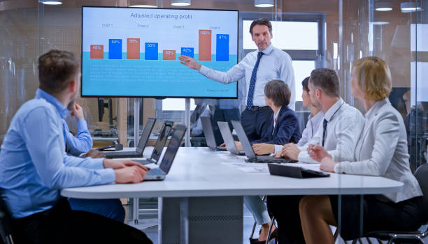 istock Businessman holding a presentation using display in glass conference room 1133565353