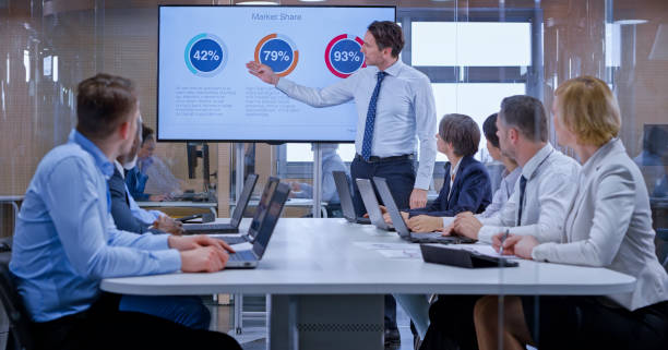 istock Businessman holding a presentation using display in glass conference room 1133565356
