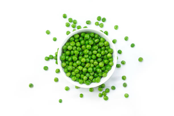 istock green peas on white bowl on white background. 1133566244
