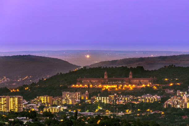 Union Buildings at dusk in Pretoria South Africa Union Buildings and Pretoria city at dusk with the magaliesberg mountain range seen behind.
Pretoria in South Africa is also known as "Jacaranda city" due to its trees planted in the city streets and parks. It is one of the capital cities, together with Cape Town and Bloemfontein. Pretoria is an academic city hosting three Universities. union buildings stock pictures, royalty-free photos & images