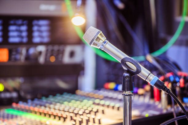 istock Microphone in the recording studio, equipment in the blurry background 1133566867