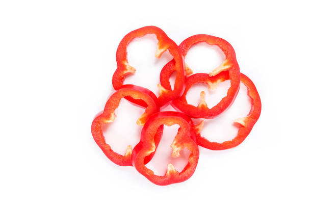 istock red bell pepper cut into pieces on white background top view. 1133566982