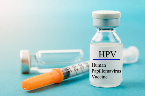 Human Papilloma Virus vaccine with syringe and vial Human Papilloma Virus vaccine with syringe and vial n laboratory background. human papilloma virus photos stock pictures, royalty-free photos & images