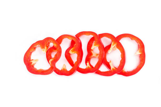 istock red bell pepper cut into pieces on white background top view. 1133567910