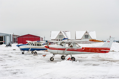 Small sport planes parked in a small airport.