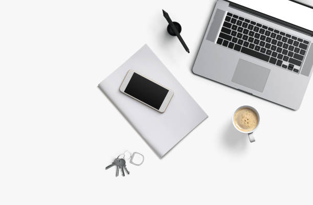 istock Office desk table with laptop computer, smartphone with black screen over a notebook and cup of coffee. Top view. 1133570457
