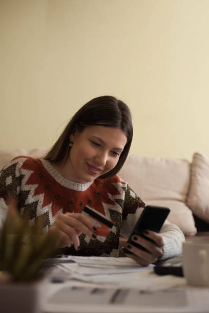 istock Woman paying bills with her smartphone . 1133570608