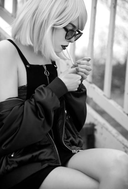 istock Young woman smoking cigarette 1133570720
