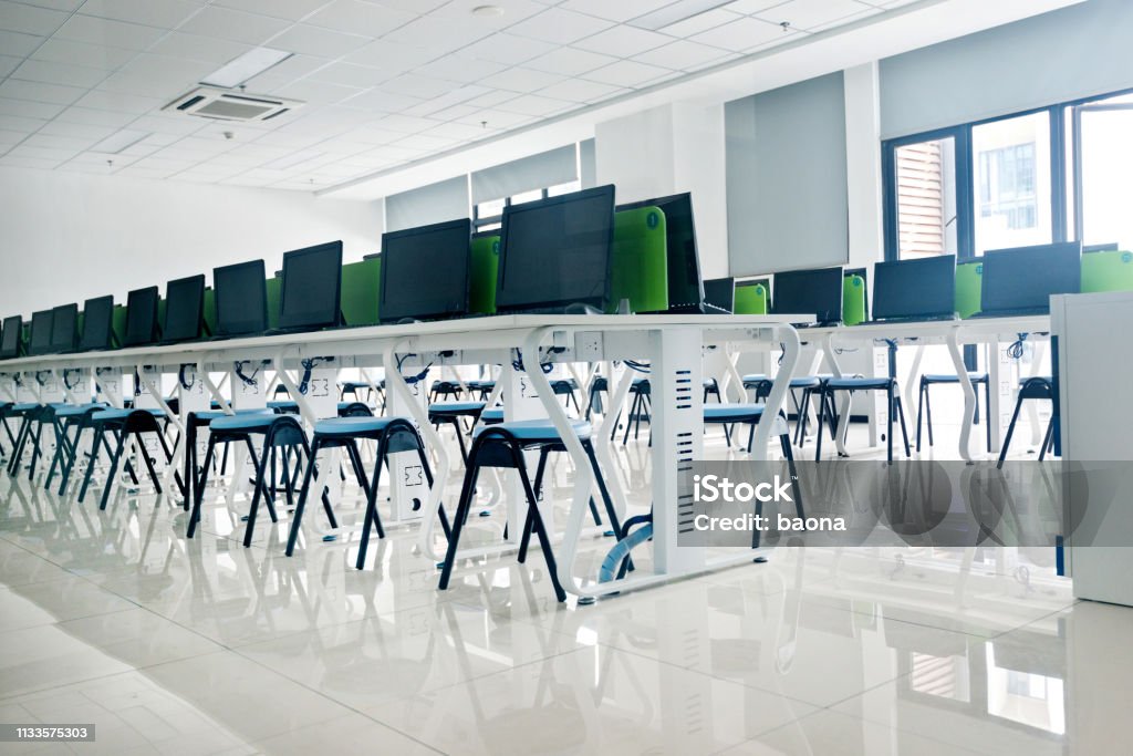 Empty computer training classroom Empty computer training classroom with desks and chairs. Computer Lab Stock Photo