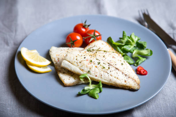 istock Fried dorado fillet with tomatoes, lemon and corn salad. 1133576514