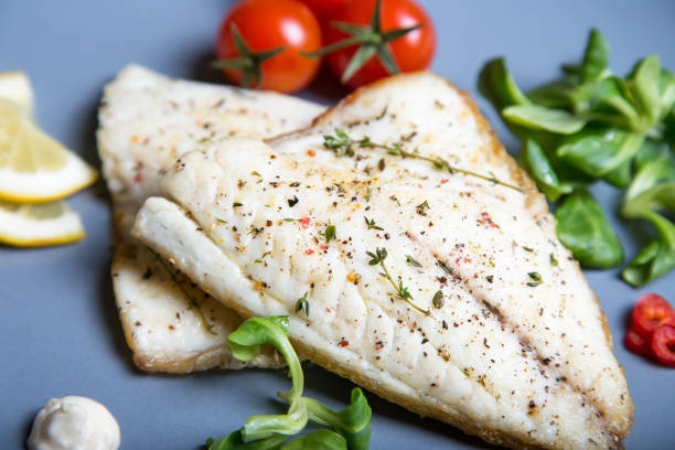 istock Fried dorado fillet with tomatoes, lemon and corn salad. 1133576527