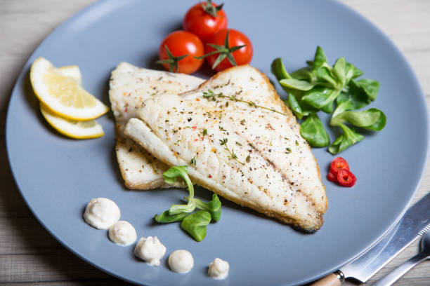 istock Fried dorado fillet with tomatoes, lemon and corn salad. 1133576546