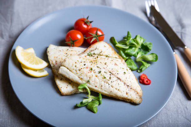 istock Fried dorado fillet with tomatoes, lemon and corn salad. 1133576562